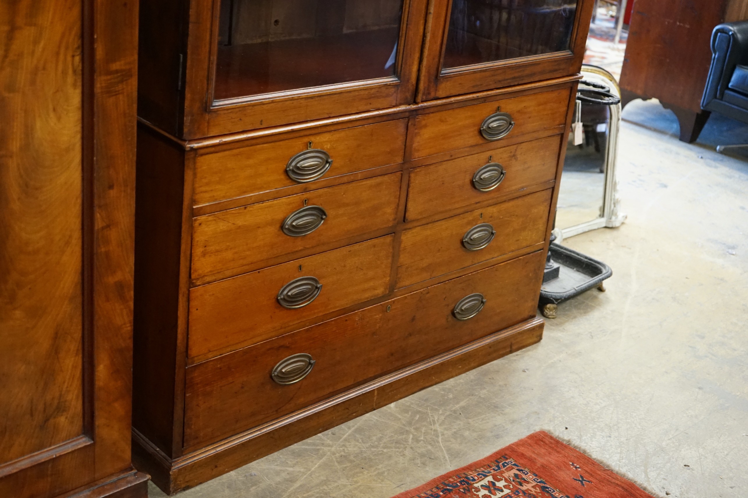 A late Victorian glazed mahogany cabinet fitted seven drawers, width 128cm, depth 56cm, height 230cm